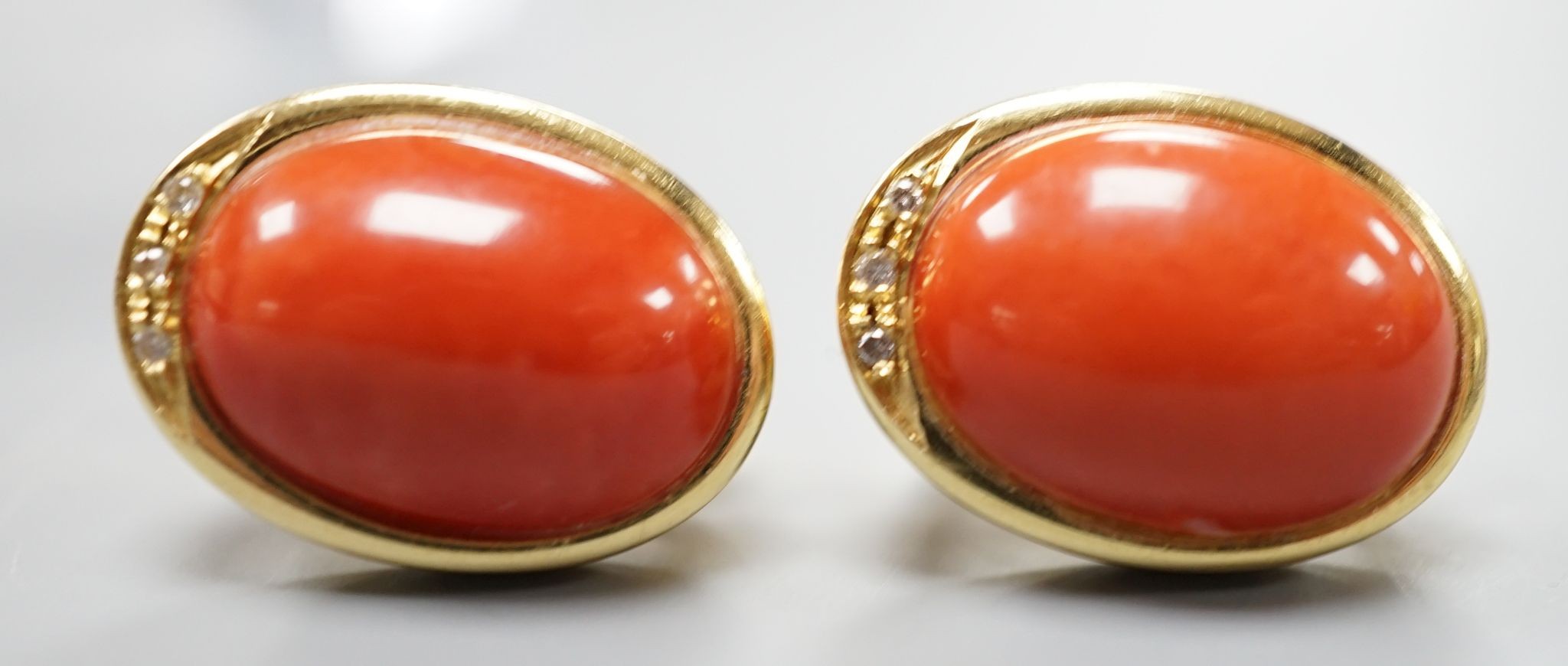 A pair of modern Italian 750 yellow metal a oval coral bead set earrings, 18mm, gross weight 11.7 grams.